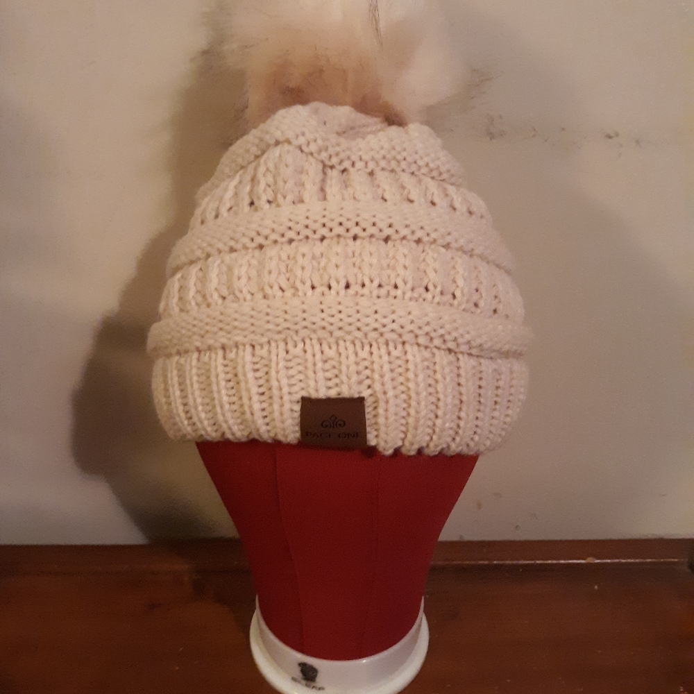 Cream )winter hat with fluffy puff ball.